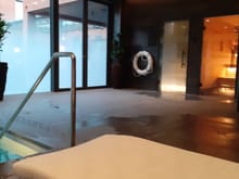 Steam room on left and sauna on  right. Smoked glass to prevent people in courtyard and in rooms opposite from seeing you swim
