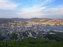View of Nagasaki  from top of Mt Insayama  on a beautiful evening  ( 30 mins before sunset)  peace park out of sight to left. Glover hill to right   Hilton  Hotel and  JR station in centre ( wind was cold that night ). Beautiful after sunset with all the lights on in the city