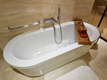 Bath with bath salts in the container on the wooden thing