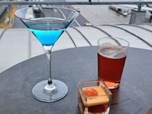 The speciallity blue cocktail and a small dessert