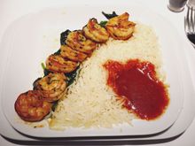 Main course Prawns on a Bed of sautéed Spinach with Tomato Sauce and Basmati Rice