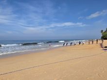 View of the beach outside the hotel in the morning, including fishermen