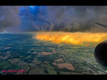 View from United 804 (HND-IAD)  approaching Washington Dulles International Airport around 7:15 pm yesterday. Sun shining through a thick patch of clouds, but it looked like wild fire.