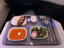 The crew decided to serve the soup and salad first instead of everything on one tray...