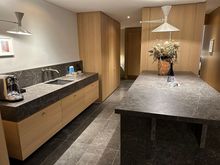 Kitchenette, which includes a refrigerator and freezer, microwave, and plenty of plates, bowls, and cups.