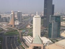 Facing north from room 4001 Conrad Dubai ( suite upgrade). Looking down on the adjacent Farimont Hotel.  Dubai frame in the middle. Dubai creek area in the distance. Windows a little dirty due to desert and summer heat haze reducing visibility.