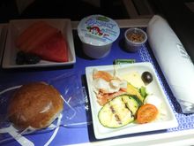 Before landing: prosciutto with manchego cheese and grilled zucchini. Fresh fruit salad. Greek yoghurt with granola.