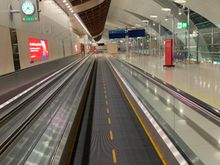Moving walkway past the J lounge toward the F section.