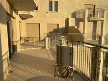 Expansive terrace with 2 tables for two persons and two sun loungers