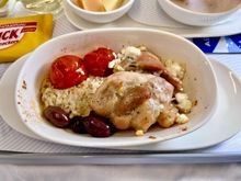 Main course chicken thigh with eggplant cream and feta cheese and olives