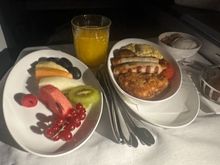 Full English breakfast and side plate of fruit