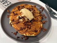 Banana pancakes w/ peanut butter chips, warm Nutella and candied macadamia nuts and salted honey butter