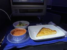 mid-flight snack (tomato soup and cheese sandwich, fruit plate)