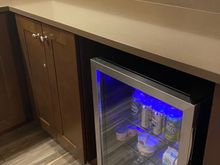 Mini fridge with sodas, water, yogurt, milk