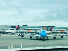KLM 747 framed with DL tails at Schipol