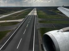 Just before touch down in runway 07C; crossing runway 18/36 looking to the south. This runway is used for departures. 