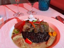 beef short rib with white curry sauce and coconut shoots cut like thin broad noodles