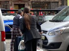 Two of the three doormen helping guests with their luggage for the taxi to the airport