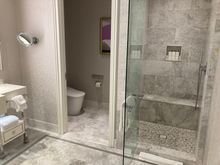 His bathroom with toilet and steam shower
