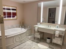 Her's bathroom with a tub fir three