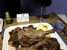 JFK-LAX dinner, lamb chops with fennel spice rub and dried cherry vinaigrette, roasted brussels sprouts with pancetta ham and creamy polenta with fontina