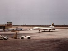 Bahrain, May 1980.   Watching from the gate as Concorde arrives from SIN, with SQ livery on port side, and BA on starboard.