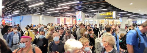 Crowds in shopping area waiting 4 escape. 