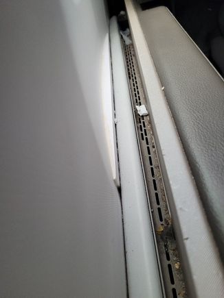 Filthy air vent between seat and wall.