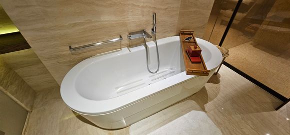 Bath with bath salts in the container on the wooden thing