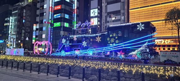 The steam locomotive outside Shimbashi JR station with Santa