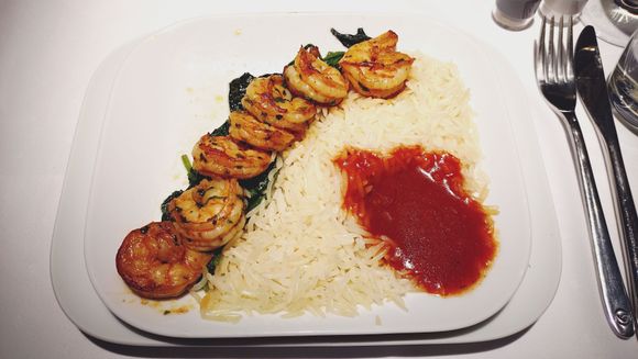 Main course Prawns on a Bed of sautéed Spinach with Tomato Sauce and Basmati Rice