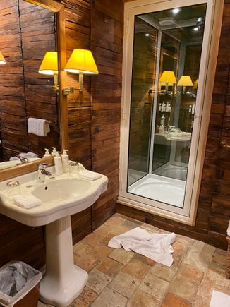 Small but functional main upstairs suite bathroom with small shower and claw foot tub (out of photo) at the Centaure cottage at Domaine des Etangs.