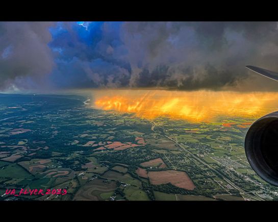 View from United 804 (HND-IAD)  approaching Washington Dulles International Airport around 7:15 pm yesterday. Sun shining through a thick patch of clouds, but it looked like wild fire.