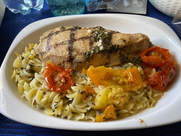 Chicken with orzo and tomatoes.  Decent flavor for plane food!