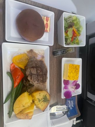 Shockingly good in F from KOA-SEA today, 8/2 AS854. That would be a Taro/Ube (couldn’t tell) roll, with the beef filet, salad, and a sort of passionfruit cake. Normally meals are decent, good microwave quality, but today was awesome. Great job Alaska!

We did not get a cookie but perhaps the cake makes up for that.