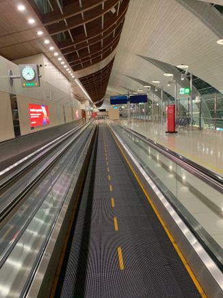 Moving walkway past the J lounge toward the F section.