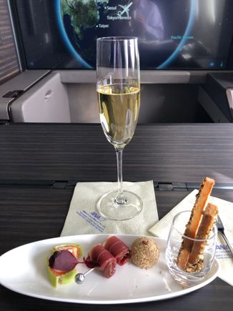 Meal service on this flight started with Krug champagne and a few appetizers. I won't do a picture of the menu since that's online. I requested the Japanese menu + Caviar. Left to Right they are: Spinach and Salmon wrap, Duck slices, Foie Gras ball, and breadsticks.