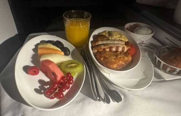Full English breakfast and side plate of fruit