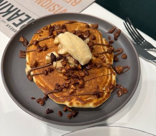 Banana pancakes w/ peanut butter chips, warm Nutella and candied macadamia nuts and salted honey butter