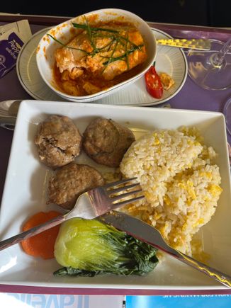 An eggy rice, slice of carrot, baby pan choi, three beef burgers and the salmon.