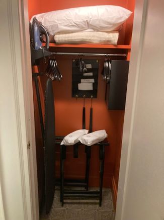 Extra closet in the bedroom with the safe, iron & board, shoehorn, extra pillow and blanket