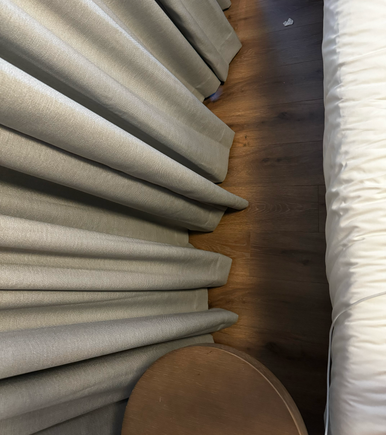 Side of bed by wall/window.