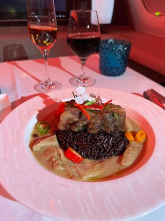 beef short rib with white curry sauce and coconut shoots cut like thin broad noodles