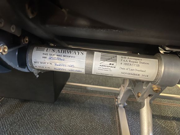 US Airways inventory tag underneath one of the first class seats. 