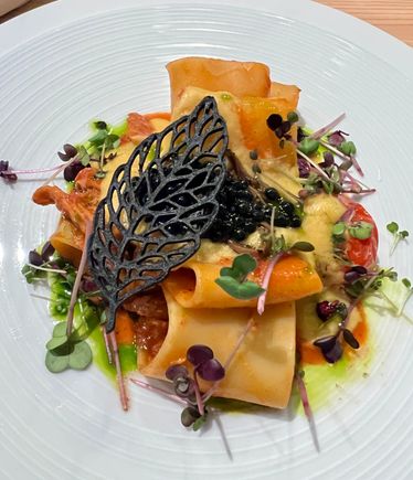 Incredible sauce on this pasta from Paradiso Pure. Dish is paccheri with seitan cream, truffle and vegan caviar, saffron, smoked corn cream & yuzu.