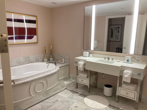 Her's bathroom with a tub fir three