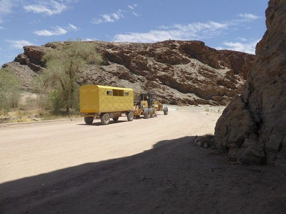 A grader and his caravan at The Gaub Pass, just north of the Tropic of Capricorn. They seem to spend days out in remote spots maintining ther roads.
