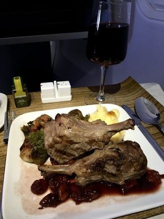 JFK-LAX dinner, lamb chops with fennel spice rub and dried cherry vinaigrette, roasted brussels sprouts with pancetta ham and creamy polenta with fontina