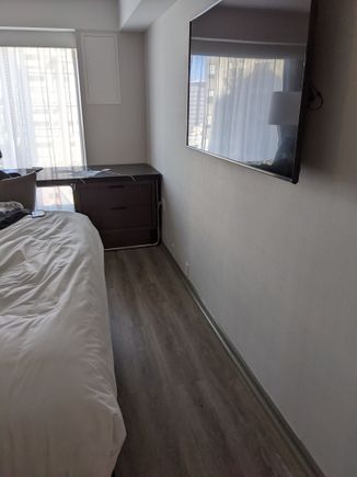 Original "upgraded" room where you can barely walk past the bed without hitting the wall mounted TV. 