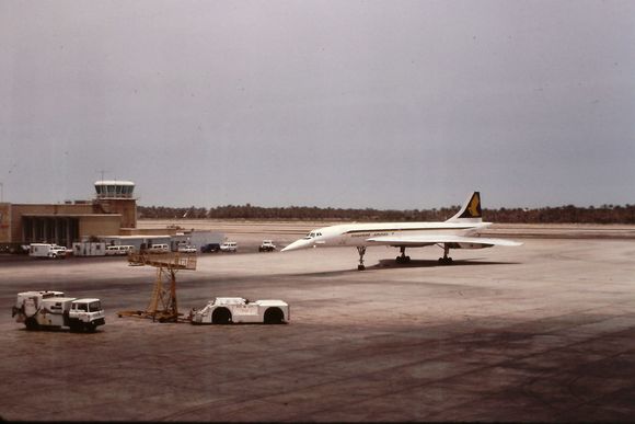 Bahrain, May 1980.   Watching from the gate as Concorde arrives from SIN, with SQ livery on port side, and BA on starboard.